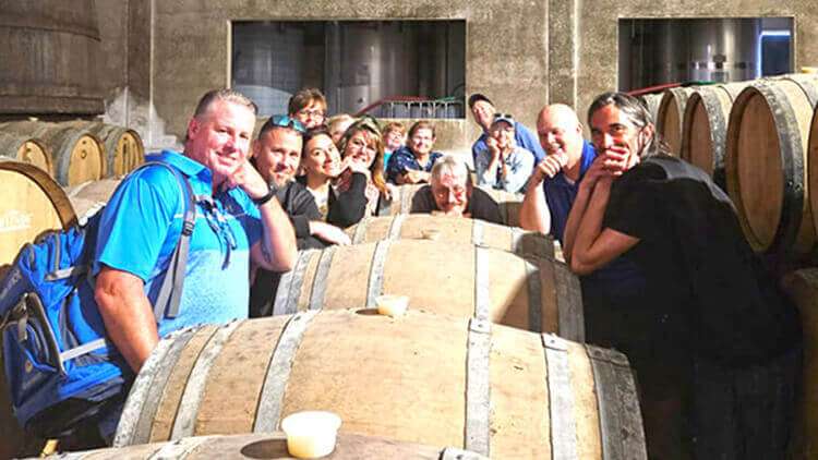 Group of guests with António at the wine cellar